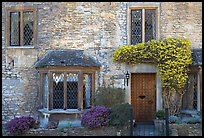 Stone house facade with flowers, Castle Combe. Wiltshire, England, United Kingdom ( color)