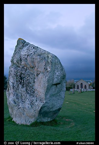 Standing stone and chapel at dusk, Avebury, Wiltshire. England, United Kingdom
