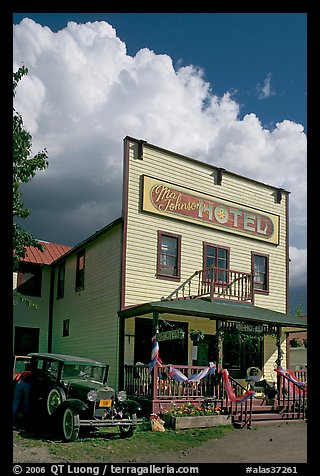 Ma Johnson hotel with classic car parked by, afternoon. McCarthy, Alaska, USA (color)