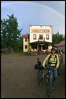 Women with bikes, hotel, and rainbow. McCarthy, Alaska, USA (color)