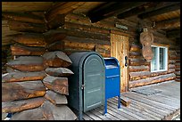 Mail boxes, log house postal office, Slana. Alaska, USA (color)