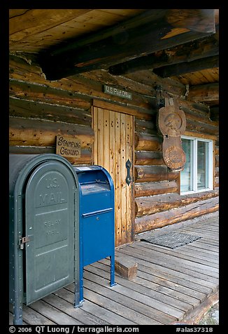 postal boxes, log house postal office, Slana. Alaska, USA (color)