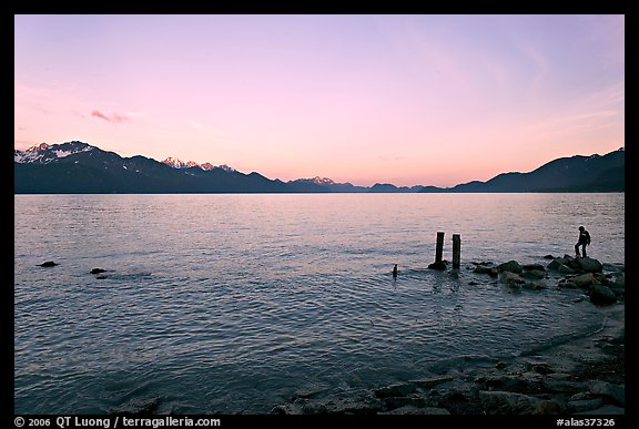 Boy standing in front of Resurrection Bay, sunset. Seward, Alaska, USA