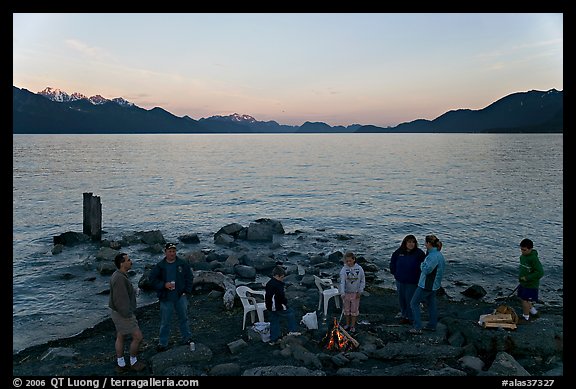 Families pickniking with fire, Resurrection Bay, sunset. Seward, Alaska, USA