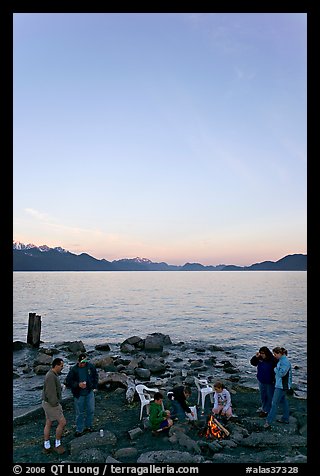 Family enjoying midnight picknik, Resurrection Bay, sunset. Seward, Alaska, USA (color)