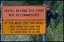 Sign with warnings about winter travel, Exit Glacier Road. Seward, Alaska, USA