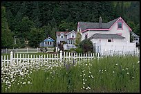 White picket fence and houses with pastel trims. Seward, Alaska, USA (color)