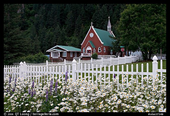 Flowers, white picket fence and church. Seward, Alaska, USA (color)