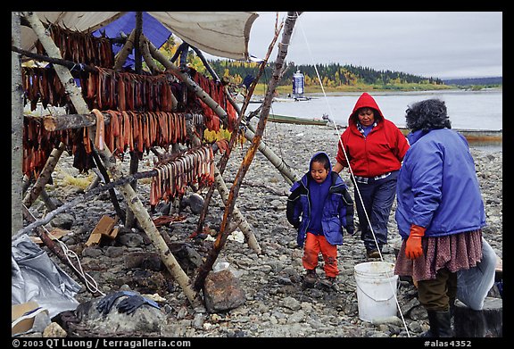 Inupiaq Eskimo family with stand of dried fish, Ambler. North Western Alaska, USA (color)