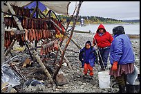 Inupiaq Eskimo family with stand of dried fish, Ambler. North Western Alaska, USA (color)