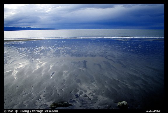 Sand patterns and stormy skies on the Bay. Homer, Alaska, USA