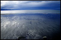 Sand patterns and stormy skies on the Bay. Homer, Alaska, USA