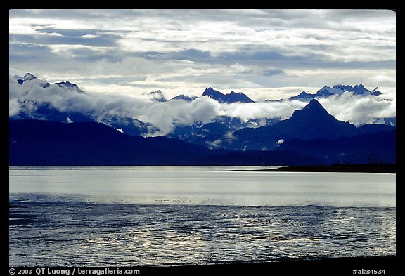 Low clouds haning over Kenai Mountains across Katchemak Bay. Homer, Alaska, USA