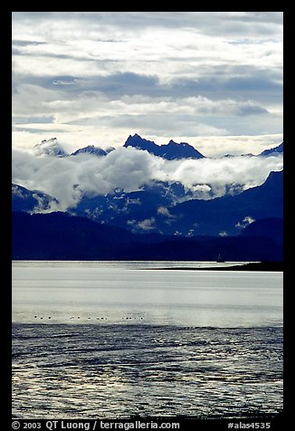 Low clouds hanging over Kenai Mountains across Katchemak Bay. Homer, Alaska, USA