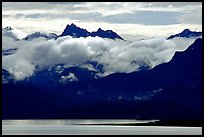 Mountains rising above bay with low clouds. Homer, Alaska, USA ( color)