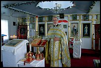 Orthodox priest inside the old Russian church. Ninilchik, Alaska, USA (color)