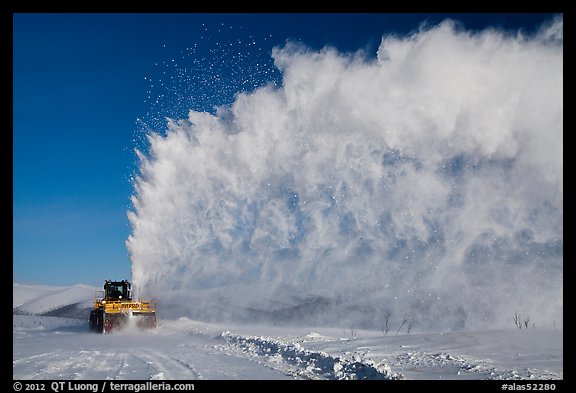 Snow plow truck with cloud of snow. Alaska, USA