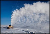 Snow plow truck with cloud of snow. Alaska, USA (color)