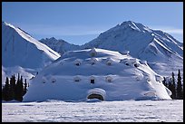 Snowy dome-shaped building and mountains. Alaska, USA