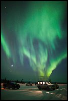 Northern Lights dance above snowy parking lot. Alaska, USA (color)