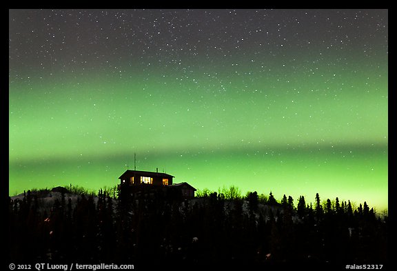 House and Northern Lights filled sky. Alaska, USA