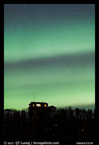 Hilltop house and Aurora Borealis. Alaska, USA