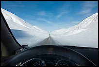 Road in wintry landscape seen from dashboard indicating -32F temperature. Alaska, USA (color)