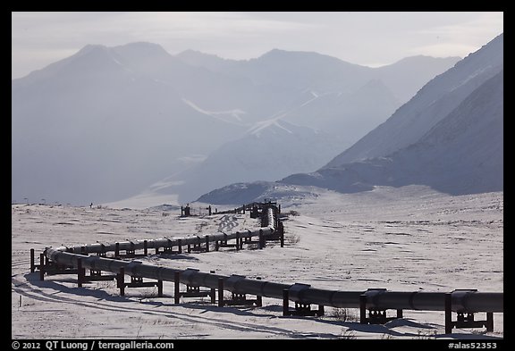 Alaska Pipeline snaking below Arctic Brooks mountains in winter. Alaska, USA