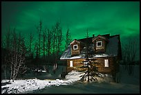 Cabin at night with Aurora Borealis. Wiseman, Alaska, USA