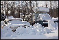 Trucks covered with piles of snow. Wiseman, Alaska, USA (color)