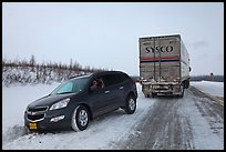 Commercial truck towing car, Dalton Highway. Alaska, USA