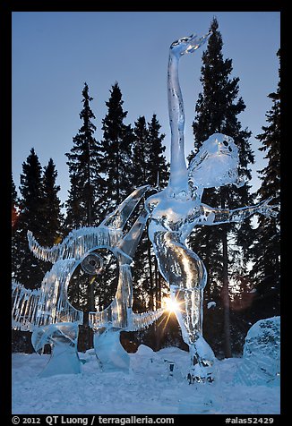 Sun setting over ice sculpture, World Ice Art Championships. Fairbanks, Alaska, USA (color)