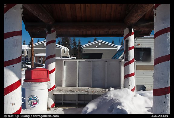 Bus stop with red candy-like stripped columns. North Pole, Alaska, USA