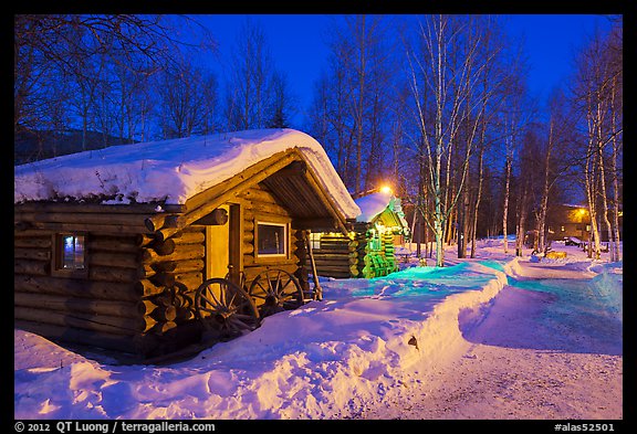 Path in snow and cabins at night. Chena Hot Springs, Alaska, USA