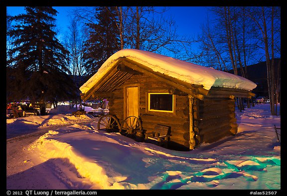 Snowy log cabin at night. Chena Hot Springs, Alaska, USA