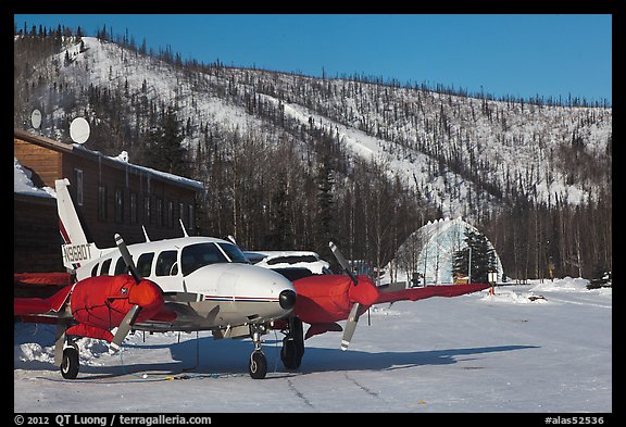 Plane with engine block warmers on frozen runway. Chena Hot Springs, Alaska, USA