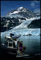 Kayakers unloading from the water taxi at Black Sand Beach. Prince William Sound, Alaska, USA (color)