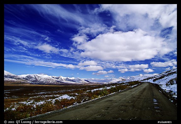 Denali Highway under large white clouds. Alaska, USA