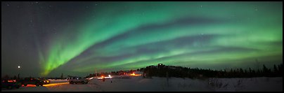 Northern Lights streaking above cars and cabin at Cleary Summit. Alaska, USA (Panoramic color)