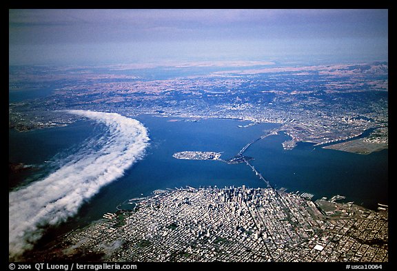 Aerial view of narrow band of fog rolling in from the Golden Gate besides the city. San Francisco, California, USA (color)