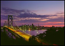 Bay Bridge and city skyline with lights at sunset. San Francisco, California, USA ( color)