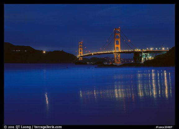 Golden Gate Bridge reflected in wet sand, blue hour. San Francisco, California, USA (color)