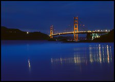 Golden Gate Bridge reflected in wet sand, blue hour. San Francisco, California, USA