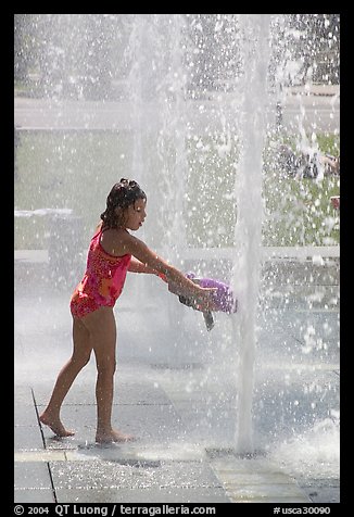 Girl refreshing herself, Cesar de Chavez Park. San Jose, California, USA
