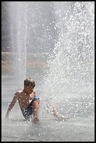 Boy playing in water,  Cesar de Chavez Park. San Jose, California, USA