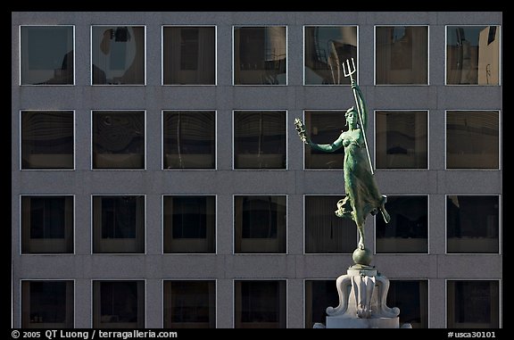 Statue on Admiral Dewey memorial column in front of modern building. San Francisco, California, USA (color)