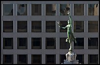 Statue on Admiral Dewey memorial column in front of modern building. San Francisco, California, USA ( color)