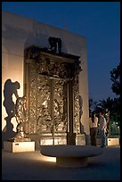 A couple contemplates Rodin's Gates of Hell at night. Stanford University, California, USA ( color)