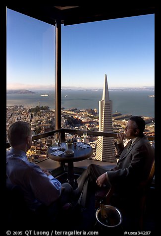 Businessmen with a bottle of Champagne in the Carnelian Room with panoramic view of the City. San Francisco, California, USA