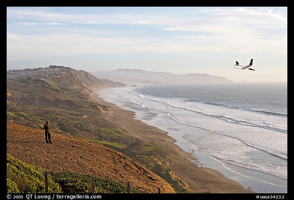 Man piloting model glider, Fort Funston, late afternoon. San Francisco, California, USA (color)